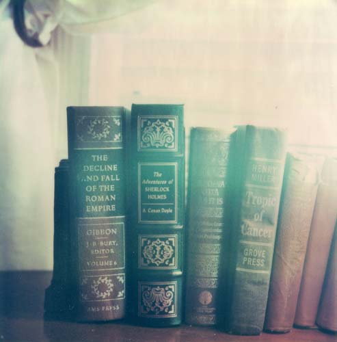 A stack of books is illuminated by back light