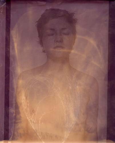 A nude model with eyes closed and gaze somewhat upward is contact printed with plants on top in white. Tendrils of light leak paint the image.
